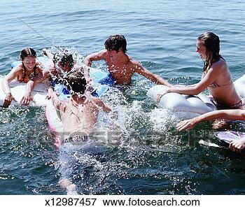 Picture - group of teens 
(16-18) playing 
in lake, elevated 
view. fotosearch 
- search stock 
photos, pictures, 
images, and photo 
clipart