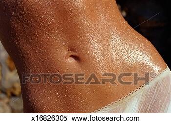 Stock Image - woman with drops 
of water on body, 
mid section. fotosearch 
- search stock 
photos, pictures, 
images, and photo 
clipart