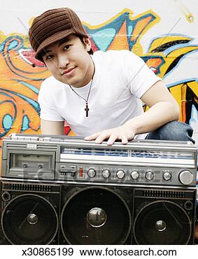 Stock Photograph - young man with 
boom box, crouching 
in front of graffiti 
covered wall. 
fotosearch - search 
stock photos, 
pictures, images, 
and photo clipart