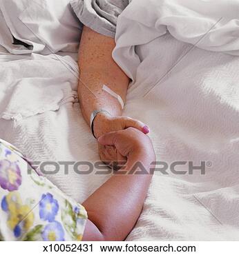 Stock Photography - nurse holding 
senior patient's 
hand, close-up 
of hands. fotosearch 
- search stock 
photos, pictures, 
images, and photo 
clipart