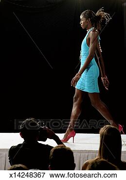 Picture - fashion model 
walking on catwalk 
during fashion 
show, side view. 
fotosearch - search 
stock photos, 
pictures, images, 
and photo clipart