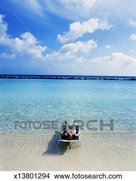 Stock Photo - leeward dutch 
antilles, aruba, 
woman lying on 
tropical beach. 
fotosearch - search 
stock photos, 
pictures, images, 
and photo clipart