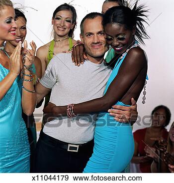 Stock Photograph - models surrounding 
fashion designer 
on catwalk after 
fashion show. 
fotosearch - search 
stock photos, 
pictures, images, 
and photo clipart