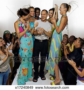 Stock Photograph - models surrounding 
fashion designer 
on catwalk after 
fashion show. 
fotosearch - search 
stock photos, 
pictures, images, 
and photo clipart