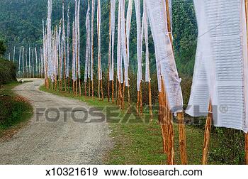 Stock Photograph - bhutan, trashigang, 
dirt roadway lined 
with prayer flags. 
fotosearch - search 
stock photos, 
pictures, images, 
and photo clipart