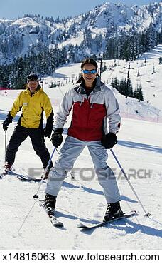 Stock Photo - male ski instructor 
teaching woman 
to downhill ski. 
fotosearch - search 
stock photos, 
pictures, images, 
and photo clipart