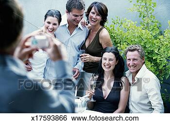 Stock Photo - man taking digital 
photograph of 
five adults (focus 
on five adults). 
fotosearch - search 
stock photos, 
pictures, images, 
and photo clipart