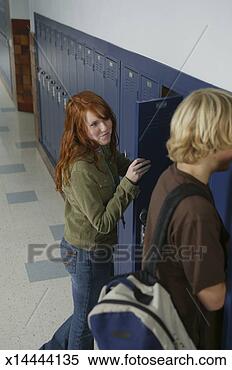 Stock Image - teenage boy and 
girl (14-16) at 
lockers, girl 
smiling at boy. 
fotosearch - search 
stock photos, 
pictures, images, 
and photo clipart