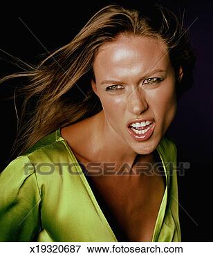 Picture - woman pulling 
facial expression, 
hair blowing, 
close-up. fotosearch 
- search stock 
photos, pictures, 
images, and photo 
clipart