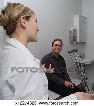 Stock Photo - man sitting in 
doctors office, 
female doctor 
gesturing with 
hands. fotosearch 
- search stock 
photos, pictures, 
images, and photo 
clipart