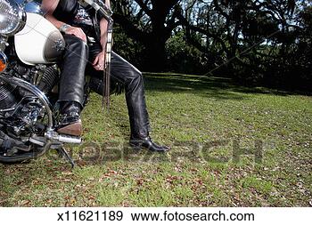 Stock Photograph - mature man sitting 
on stationary 
motorbike, low 
section. fotosearch 
- search stock 
photos, pictures, 
images, and photo 
clipart