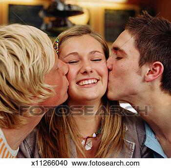 Stock Photography - teenage girl (15-17) 
being kissed by 
teenage boy and 
young man. fotosearch 
- search stock 
photos, pictures, 
images, and photo 
clipart