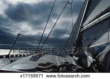 Stock Photography - yacht sailing 
into approaching 
storm (grainy). 
fotosearch - search 
stock photos, 
pictures, images, 
and photo clipart