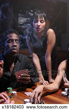Stock Photo - young woman watching 
group of young 
adults play poker. 
fotosearch - search 
stock photos, 
pictures, images, 
and photo clipart