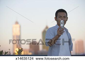 Stock Photo - australia, perth, 
man taking picture 
of himself with 
camera phone. 
fotosearch - search 
stock photos, 
pictures, images, 
and photo clipart