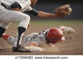 Stock Photo - base runner sliding 
into base, fielder 
catching ball 
in baseball game. 
fotosearch - search 
stock photos, 
pictures, images, 
and photo clipart