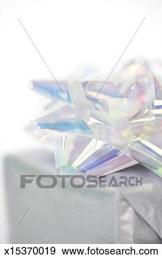 Stock Photograph - gift with iridescent 
bow, close-up 
(focus on bow). 
fotosearch - search 
stock photos, 
pictures, images, 
and photo clipart