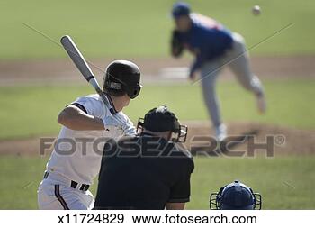 Stock Photograph - pitcher throwing 
pitch to batter, 
catcher and umpire 
in foreground. 
fotosearch - search 
stock photos, 
pictures, images, 
and photo clipart
