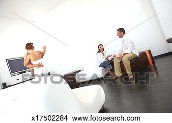 Stock Photo - two couples in 
living room, one 
couple dancing, 
one playing backgammon. 
fotosearch - search 
stock photos, 
pictures, images, 
and photo clipart