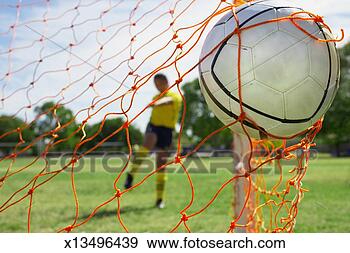 Stock Photograph - teenage girl (16-18) 
kicking soccer 
ball into goal 
(focus on ball). 
fotosearch - search 
stock photos, 
pictures, images, 
and photo clipart