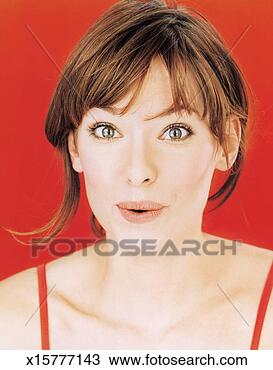 Stock Photo - young woman pulling 
facial expression, 
portrait, close-up. 
fotosearch - search 
stock photos, 
pictures, images, 
and photo clipart