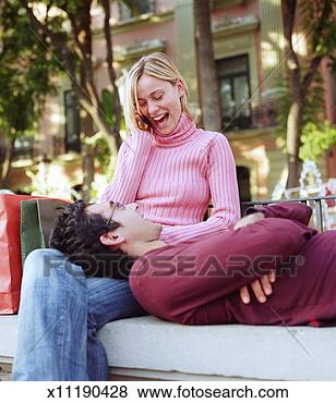Stock Photo - couple hanging 
out on city bench, 
man laying head 
on woman's lap. 
fotosearch - search 
stock photos, 
pictures, images, 
and photo clipart