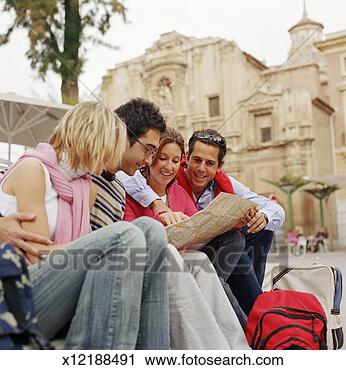 Stock Photography - four friends examining 
map. fotosearch 
- search stock 
photos, pictures, 
images, and photo 
clipart