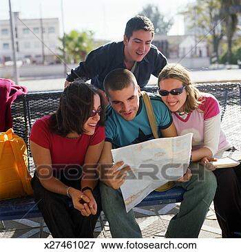 Picture - four friends looking 
at map. fotosearch 
- search stock 
photos, pictures, 
images, and photo 
clipart