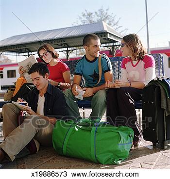 Stock Photo - four friends writing 
postcards at railway 
station. fotosearch 
- search stock 
photos, pictures, 
images, and photo 
clipart