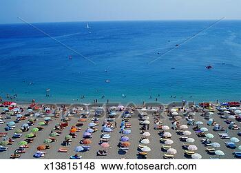 Stock Photo - greece, rhodes, 
rows of umbrellas 
and chairs on 
beach, elevated 
view. fotosearch 
- search stock 
photos, pictures, 
images, and photo 
clipart