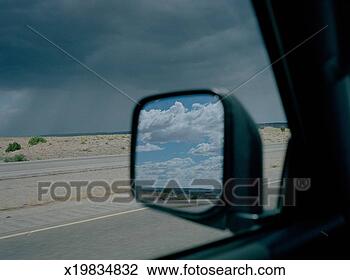 Stock Photo - stormy sky over 
desert, blue sky 
reflected in car 
side-view mirror. 
fotosearch - search 
stock photos, 
pictures, images, 
and photo clipart