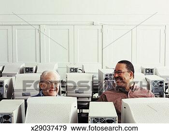 Stock Photograph - two mature men 
using computers 
in computer training 
class, smiling. 
fotosearch - search 
stock photos, 
pictures, images, 
and photo clipart