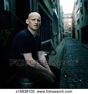 Stock Image - young man sitting 
on beer keg in 
alley, dublin, 
ireland. fotosearch 
- search stock 
photos, pictures, 
images, and photo 
clipart
