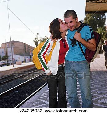 Stock Photo - young woman kissing 
friend at train 
station. fotosearch 
- search stock 
photos, pictures, 
images, and photo 
clipart