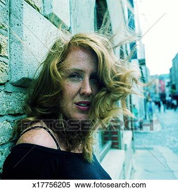 Stock Image - young woman leaning 
against building, 
portrait, dublin, 
ireland. fotosearch 
- search stock 
photos, pictures, 
images, and photo 
clipart