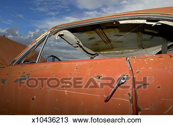 Stock Photo - battered car with 
rust patches, 
broken handle 
and windows, close-up. 
fotosearch - search 
stock photos, 
pictures, images, 
and photo clipart