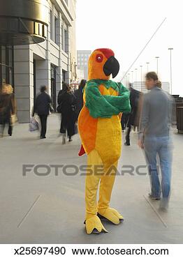 Stock Photography - man in parrot 
costume, standing 
on crowded street 
with arms folded. 
fotosearch - search 
stock photos, 
pictures, images, 
and photo clipart