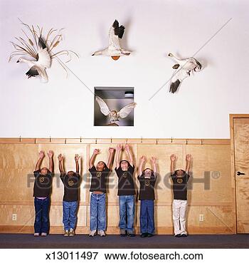 Picture - six children (4-7) 
looking up at 
stuffed birds 
on wall, arms 
raised. fotosearch 
- search stock 
photos, pictures, 
images, and photo 
clipart