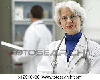 Stock Photo - doctor in office, 
male doctor in 
background, portrait. 
fotosearch - search 
stock photos, 
pictures, images, 
and photo clipart