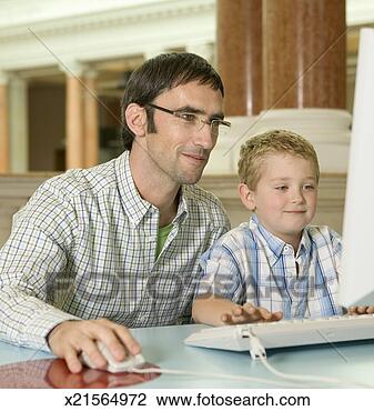 Stock Photo - father and son 
(6-8) using computer, 
son typing, father 
using mouse. fotosearch 
- search stock 
photos, pictures, 
images, and photo 
clipart