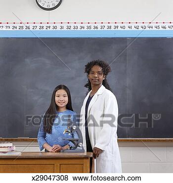 Stock Photo - female elementary 
school student 
(9-11) with science 
teacher, portrait. 
fotosearch - search 
stock photos, 
pictures, images, 
and photo clipart