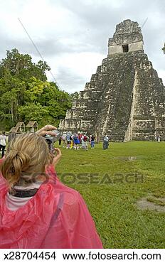 Stock Photo - woman photographing 
temple, rear view. 
fotosearch - search 
stock photos, 
pictures, images, 
and photo clipart