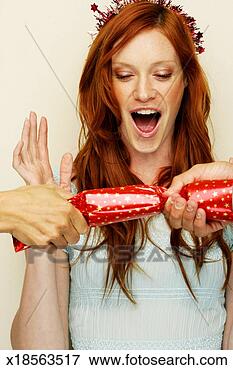 Picture - cracker being 
pulled in front 
of woman, shocked 
expression on 
face. fotosearch 
- search stock 
photos, pictures, 
images, and photo 
clipart