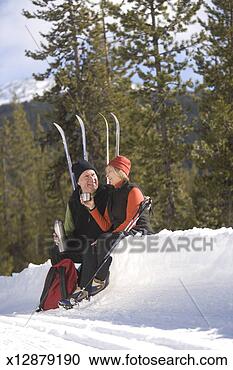 Stock Photography - senior man and 
woman with cross-country 
skis drinking 
beverage in snow. 
fotosearch - search 
stock photos, 
pictures, images, 
and photo clipart