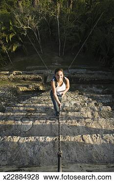 Stock Photo - young woman climbing 
up steps,  using 
rope,  at maya 
archaeological. 
fotosearch - search 
stock photos, 
pictures, images, 
and photo clipart
