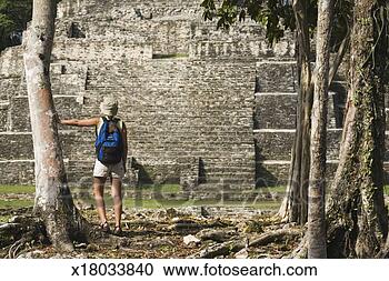 Stock Photography - young woman watching 
maya archaeological 
site of lamanai. 
fotosearch - search 
stock photos, 
pictures, images, 
and photo clipart