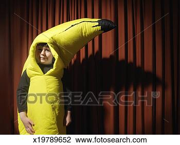 Stock Photo - boy (5-7) by stage 
curtain wearing 
banana costume, 
portrait, close-up. 
fotosearch - search 
stock photos, 
pictures, images, 
and photo clipart