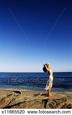 Stock Photography - woman stretching 
at beach, side 
view. fotosearch 
- search stock 
photos, pictures, 
images, and photo 
clipart