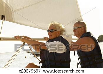 Picture - mature couple 
sailing, side 
view. fotosearch 
- search stock 
photos, pictures, 
images, and photo 
clipart