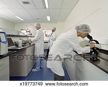 Stock Photograph - woman and two 
men wearing lab 
coats working 
in science laboratory. 
fotosearch - search 
stock photos, 
pictures, images, 
and photo clipart
